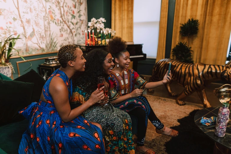 a group of women sitting on top of a green couch, pexels contest winner, black arts movement, wearing an african dress, taking a selfie, scene from a dinner party, patterned clothing