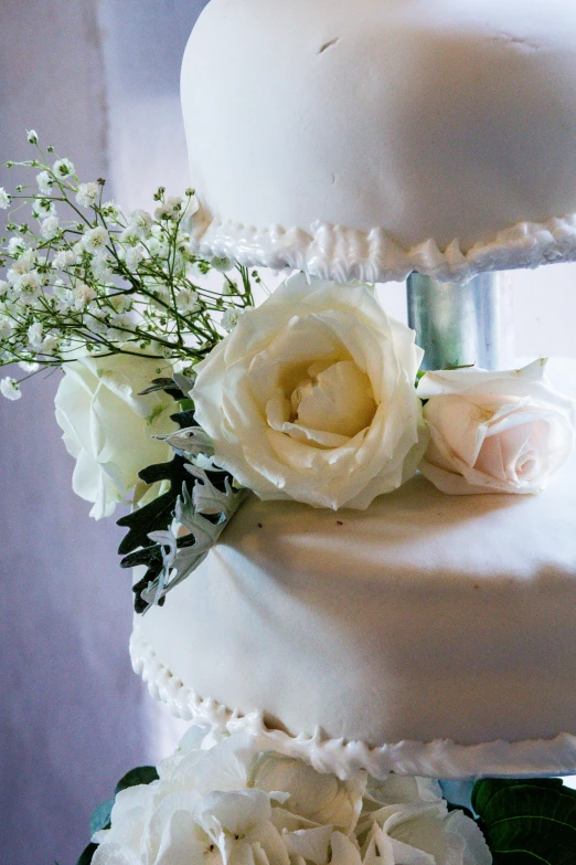 a three tiered wedding cake with white flowers, by Linda Sutton, unsplash, romanticism, closeup - view, backlighted, morning detail, porcelain