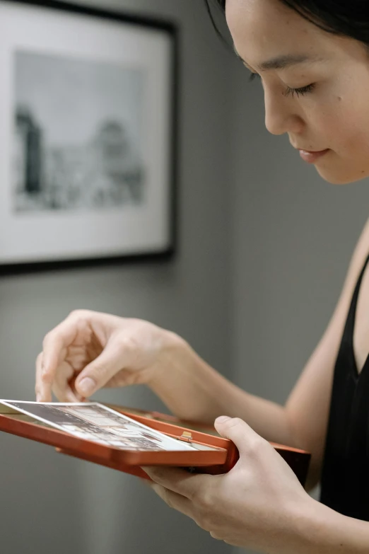 a woman holding a tablet computer in her hands, by David Simpson, pexels contest winner, digital art, lacquerware, close up shot from the side, at home, eva elfie