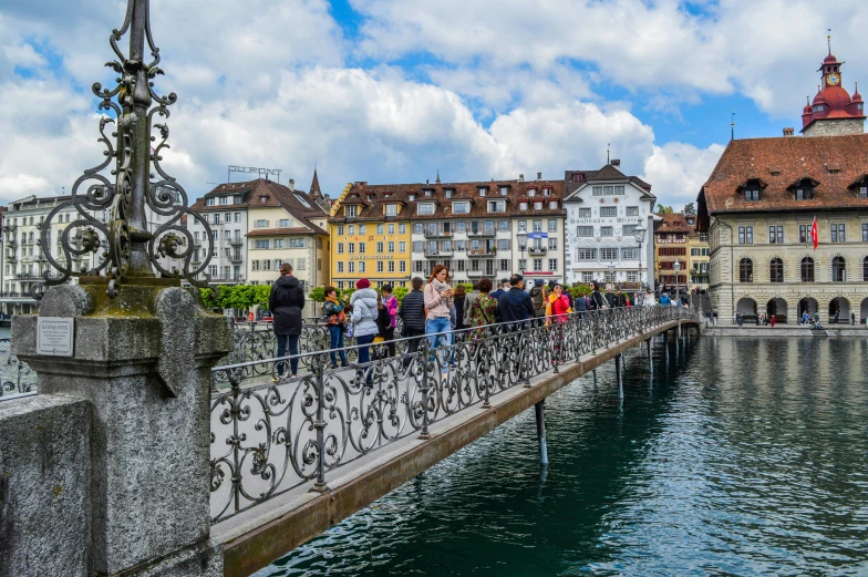 a group of people walking across a bridge over a river, by Karl Stauffer-Bern, pexels contest winner, renaissance, a brightly colored, lake view, olafur eliasson, a quaint