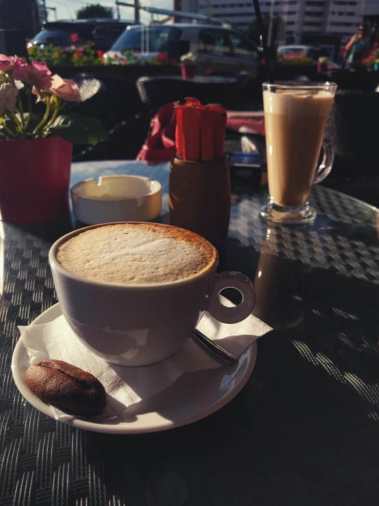 a cup of coffee sitting on top of a table, by Lucia Peka, cappuccino, at the terrace, profile image, multiple stories