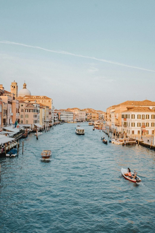 a river filled with lots of boats next to tall buildings, pexels contest winner, renaissance, venice, profile image, late afternoon, wide high angle view