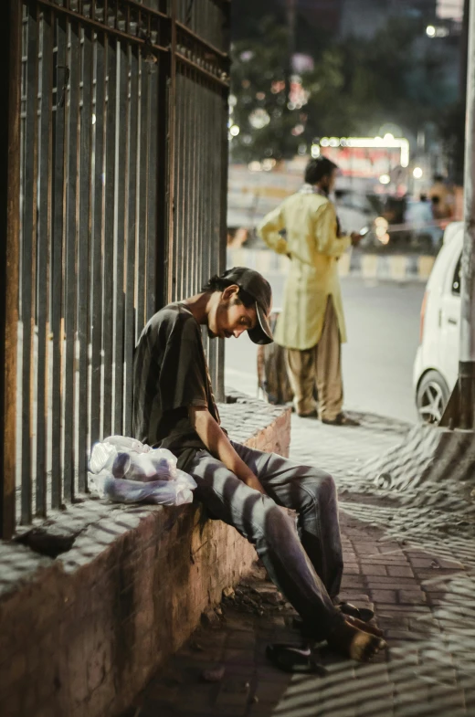 a man sitting on the side of a street, a friend in need, sickly, sleepy feeling, multiple stories