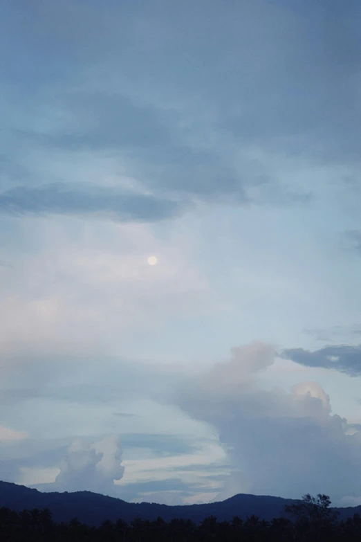 a person flying a kite on a cloudy day, by Linda Sutton, aestheticism, soft blue moonlight, instant photograph of the sky, big pink sphere high in the sky, 2019 trending photo