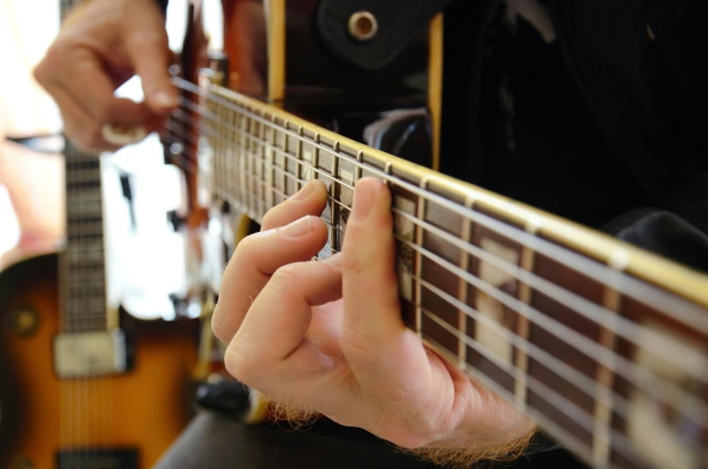 a close up of a person playing a guitar, by David Simpson, pexels, photorealism, 15081959 21121991 01012000 4k