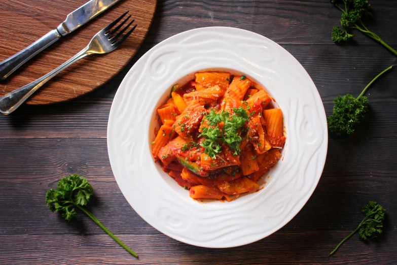 a close up of a plate of food on a table, pasta, coral red, profile image, fan favorite