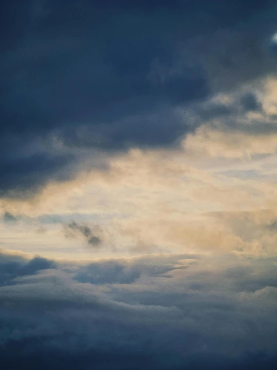 a large jetliner flying through a cloudy sky, an album cover, inspired by Elsa Bleda, unsplash, romanticism, evening sky, soft grey and blue natural light, today\'s featured photograph 4k, night clouds