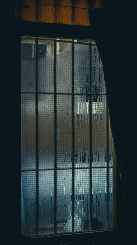 a picture of a window in a dark room, inspired by Elsa Bleda, light and space, tall factory, 1990s photograph, transparent corrugated glass, curved lines