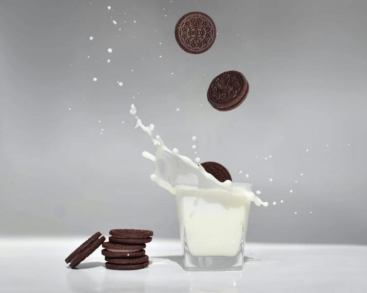 chocolate cookies falling into a glass of milk, by Glen Angus, shutterstock contest winner, photorealism, clemens ascher, black! and white colors, 🦑 design, milky white skin