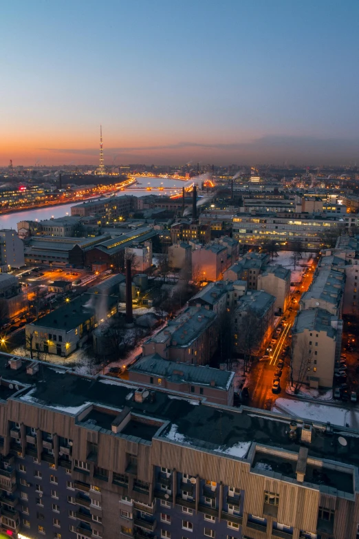 an aerial view of a city at dusk, by Sven Nordqvist, pexels contest winner, socialist realism, industrial setting, saint petersburg, panoramic widescreen view, winter