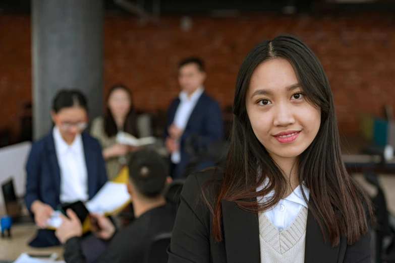 a woman standing in front of a group of people, girl in a suit, hoang lap, background image, professional photograph