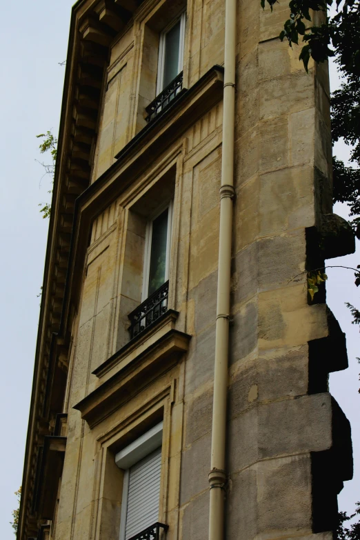 a tall building with a clock on it's side, paris school, bay window, very poor quality of photography, looking to his side, up-close