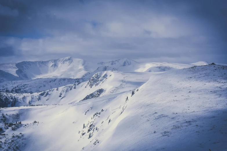 a group of people riding skis down a snow covered slope, by Peter Churcher, pexels contest winner, hurufiyya, vast mountain landscape, winter blue drapery, 90's photo, highlands