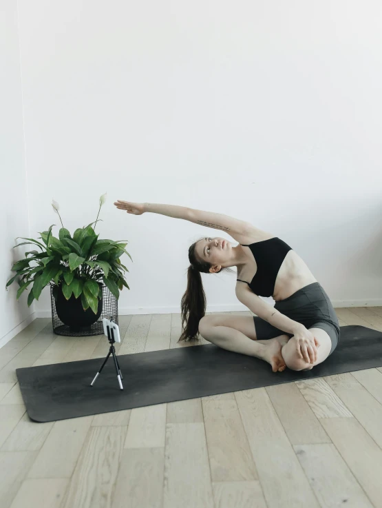 a woman doing a yoga pose on a yoga mat, a picture, pexels contest winner, figuration libre, low quality video, brunette fairy woman stretching, shot on sony a 7, half body photo