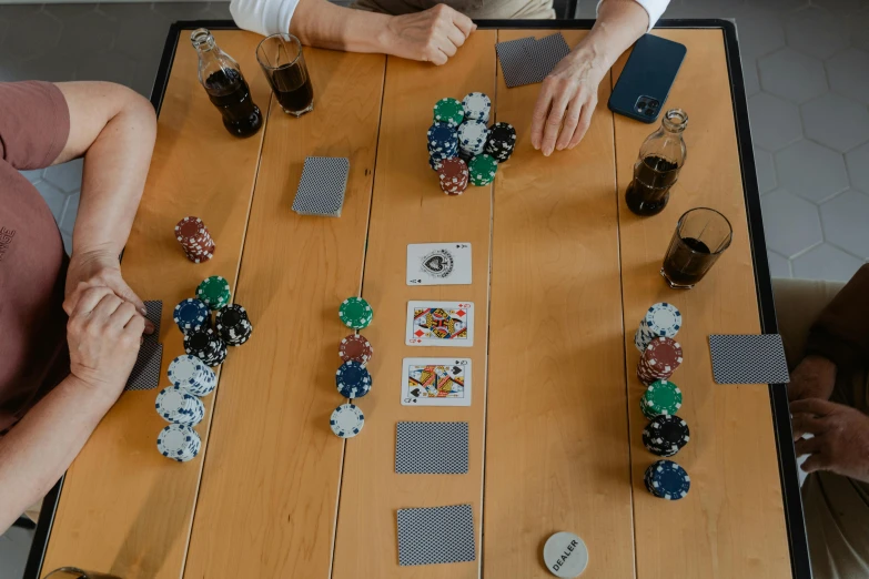 three people playing a game on wooden board