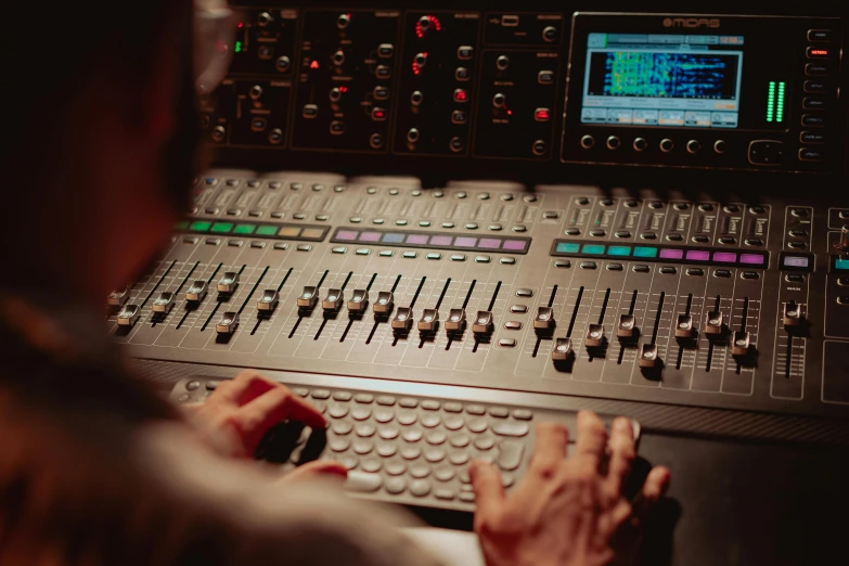 a man that is sitting in front of a mixer, unsplash, avatar image, instrument, close - up photograph, control panel