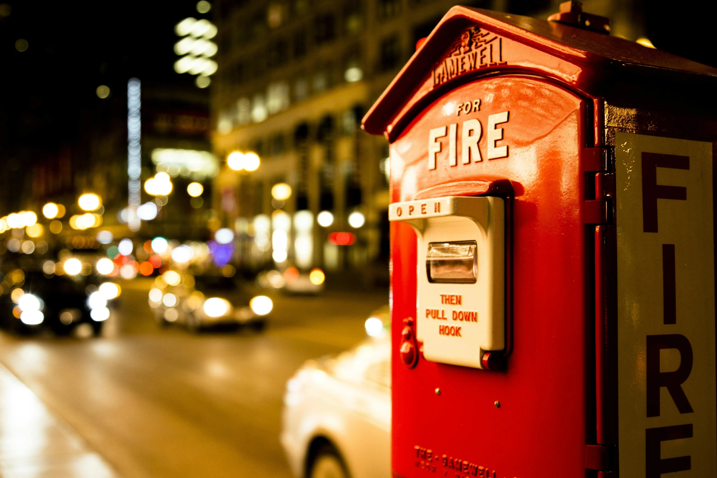 a red fire hydrant sitting on the side of a road, by Dan Luvisi, pexels contest winner, holding a postcard from chicago, vibrant city lights, square, letterbox