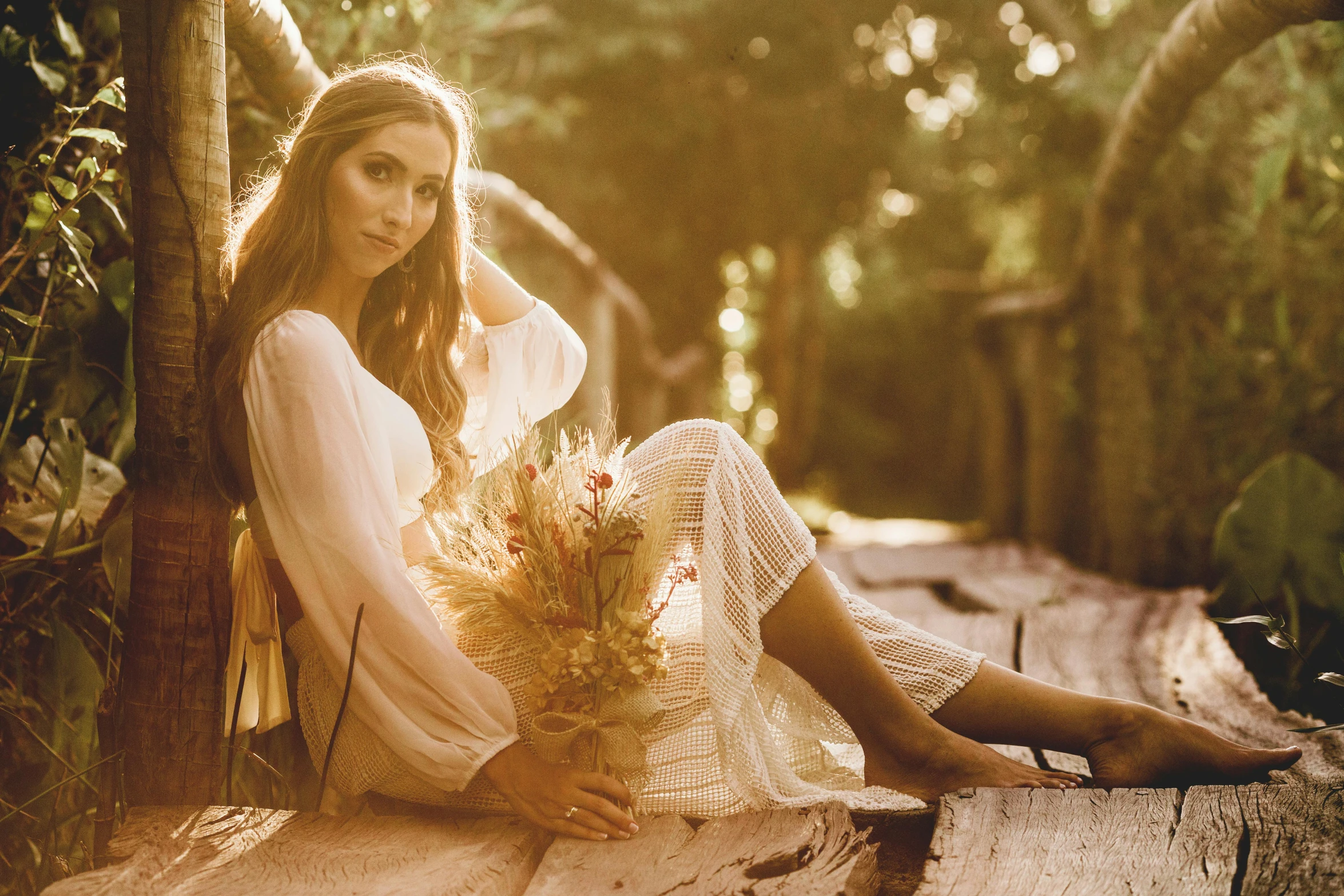 a woman sitting on a wooden bench holding a bunch of flowers, inspired by Elsa Bleda, unsplash, renaissance, long ashy hair | gentle lighting, sitting on a log, sepia sunshine, brunette