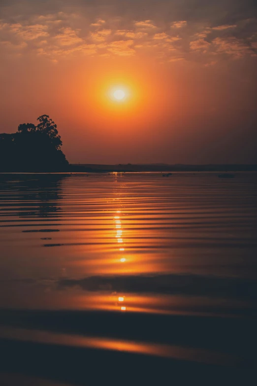 the sun is setting over a body of water, pexels contest winner, romanticism, bangladesh, glossy surface, calm environment, low detailed