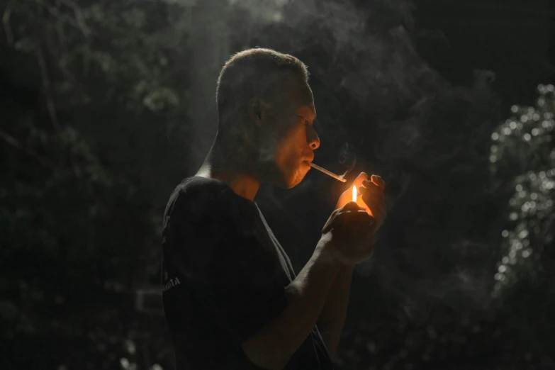 a man smoking a cigarette in the dark, by Adam Marczyński, pexels contest winner, in a dark forest low light, profile image, smoking a bowl of hash together, avatar image