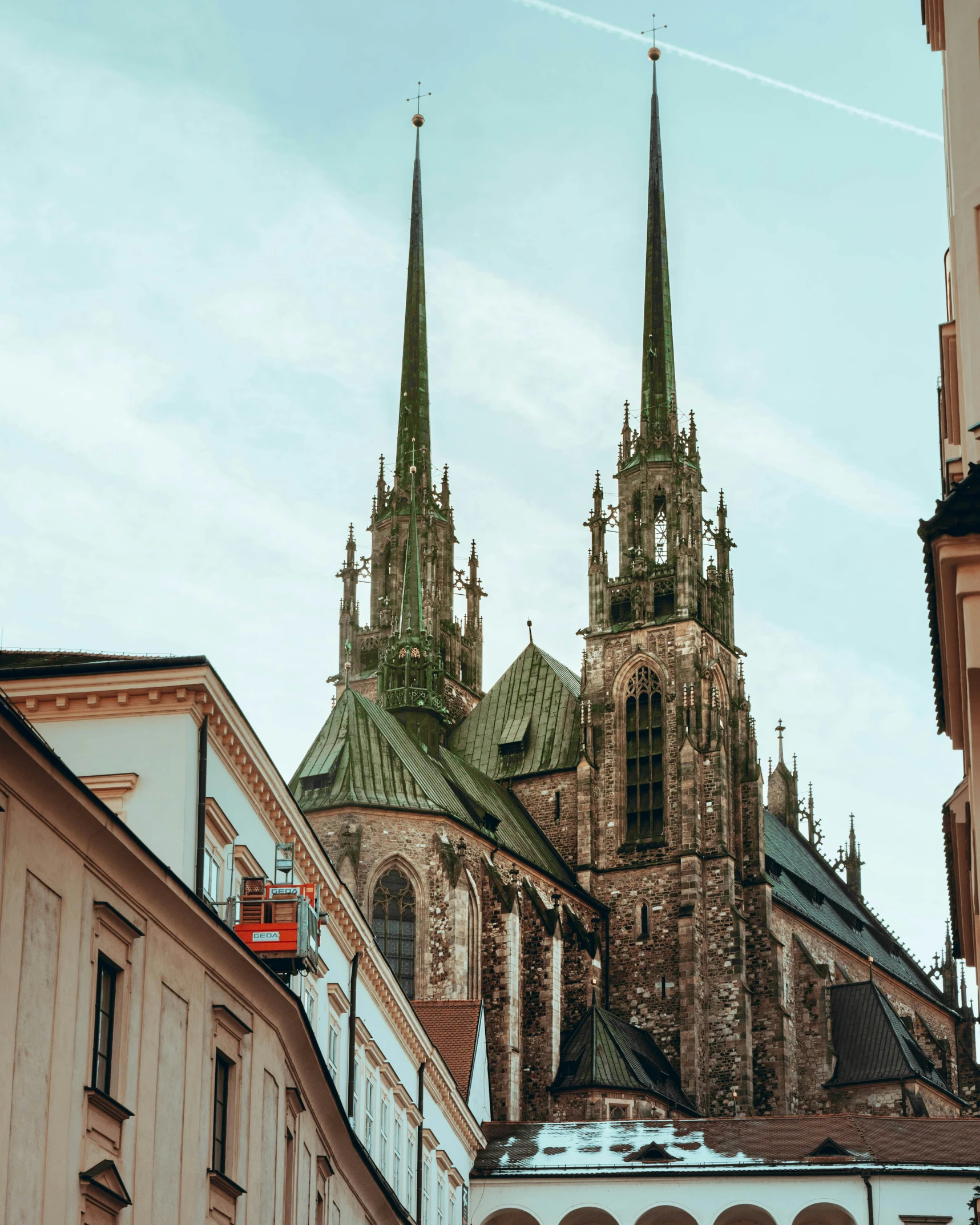 a couple of buildings that are next to each other, by Matija Jama, pexels contest winner, cathedral background, instagram post, zdzisław, lead - covered spire