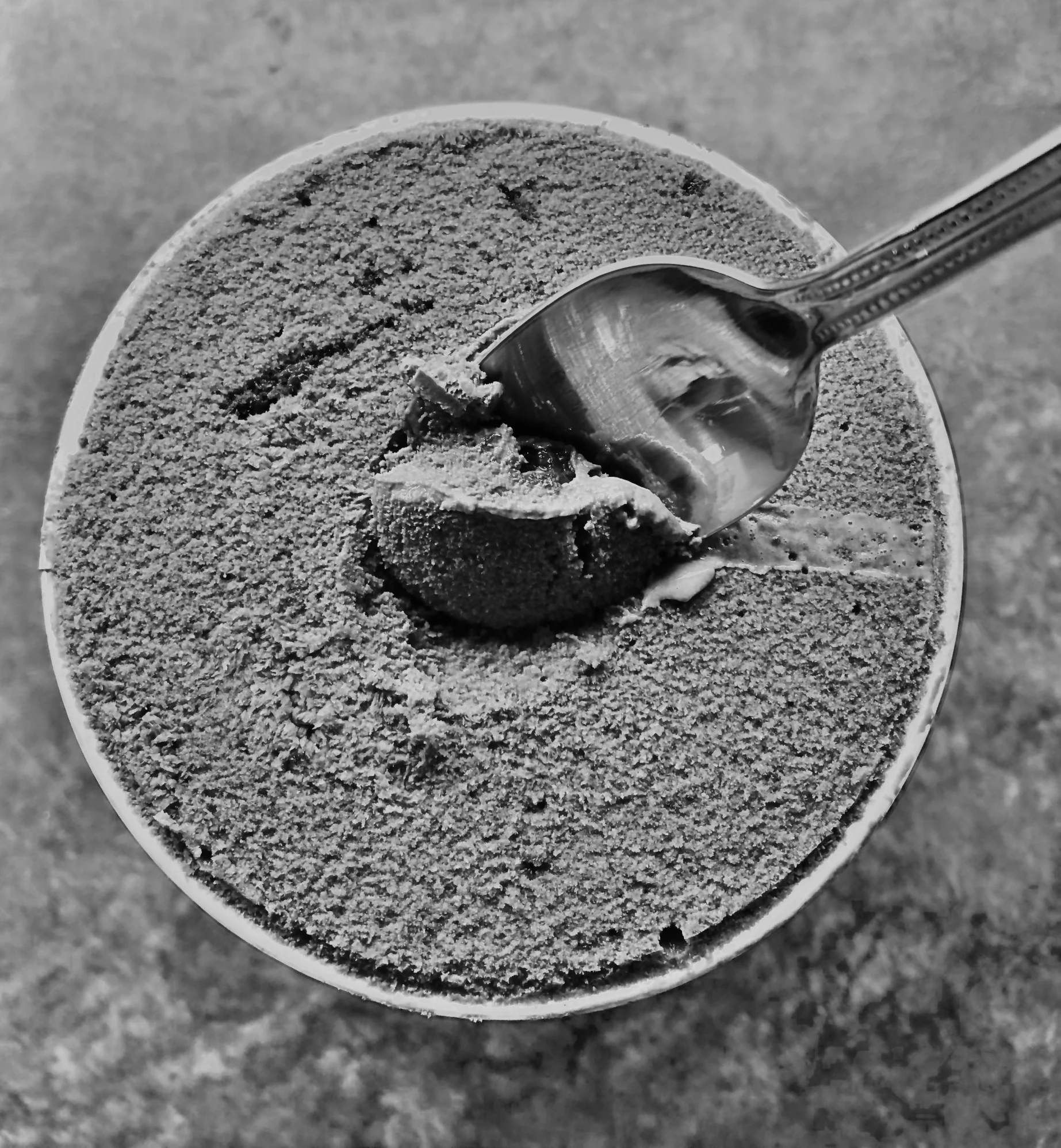 a spoon that is sitting in a bowl, a black and white photo, inspired by Edward Weston, pexels, concrete art, powdered sugar, extremely detailed sand, taken on iphone 14 pro, made of concrete