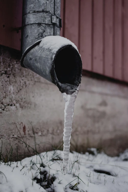 a pipe that has water coming out of it, pexels contest winner, icy cold pale silent atmosphere, head down, neighborhood, long snout