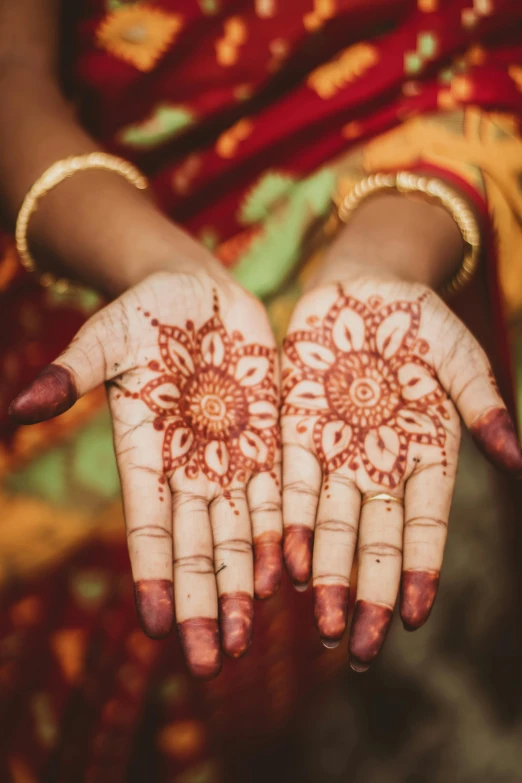 a woman's hands with henna painted on them, square, fan favorite, hand - tinted, crimson