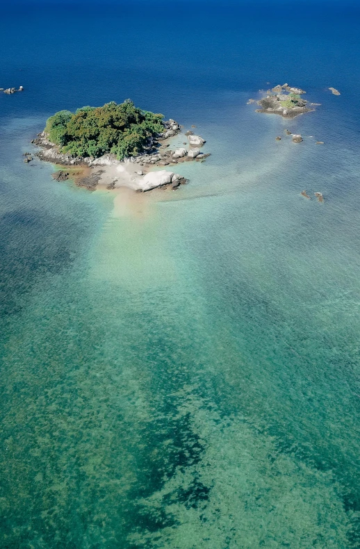 a small island in the middle of the ocean, mami wata, crystal clear blue water, lush surroundings, manly