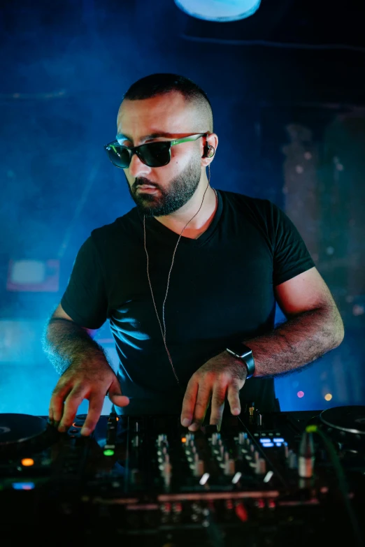 a man that is playing some kind of music, an album cover, inspired by Nadim Karam, featured on reddit, hurufiyya, dj at a party, dark shades, photo taken in 2018, dr zeus