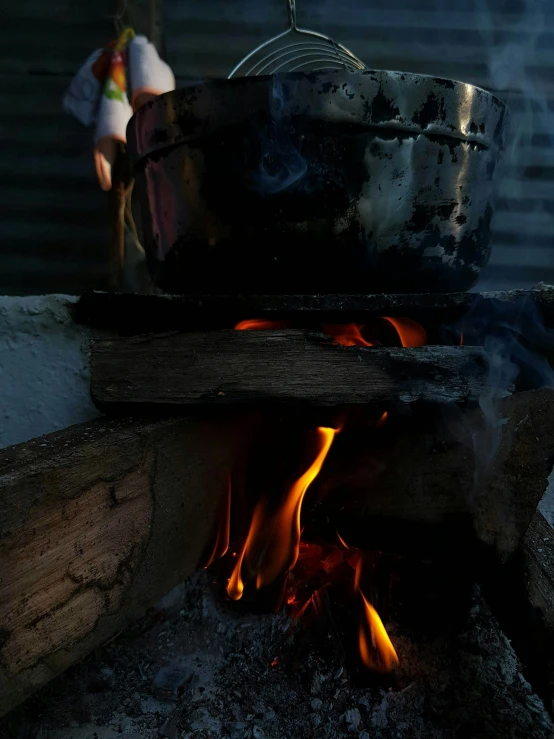 a pot sitting on top of an open fire, taken with sony alpha 9, instagram story, pouring, high quality photo