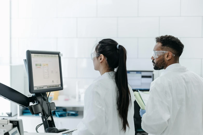 two people in lab coats looking at a computer screen, pexels, 🎨🖌️, profile image, transparent labs, instagram post