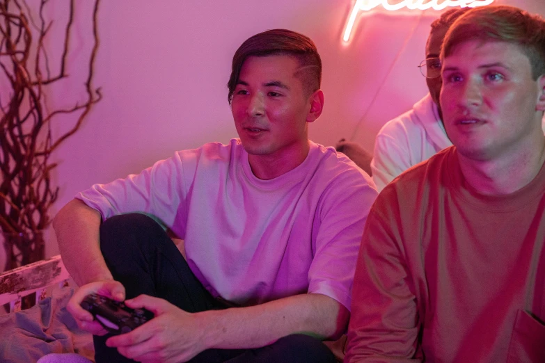 two men sitting on a couch playing a video game, an album cover, inspired by Wang Duo, pexels, realism, fuschia leds, asian descent, julian ope, chillin at the club together