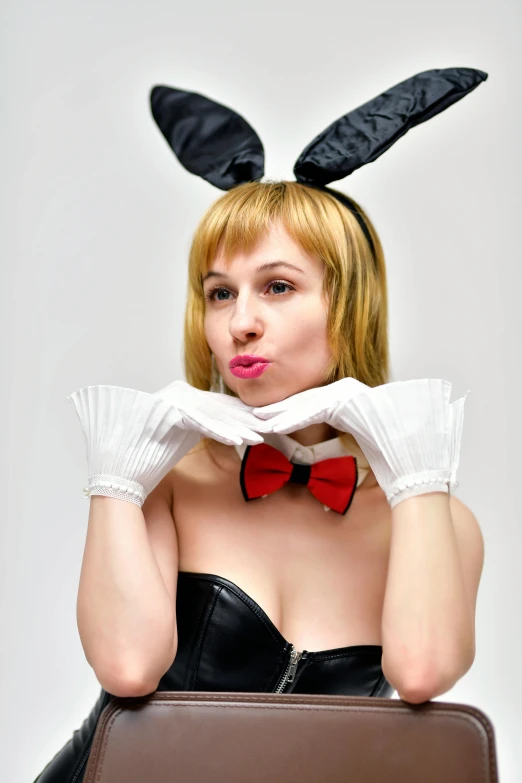 a woman wearing bunny ears sitting on top of a suitcase, inspired by Tex Avery, reddit, white satin gloves, high quality photo, headshot photo, 2263539546]