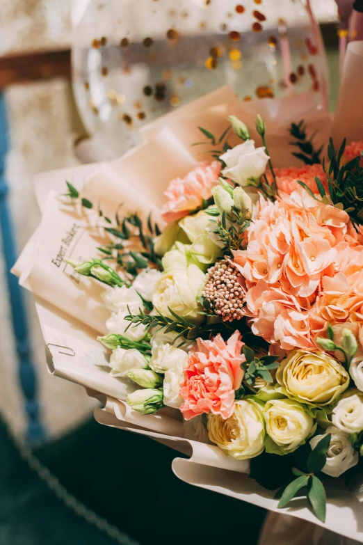 a close up of a person holding a bouquet of flowers, in shades of peach, elegantly, wrapped in flowers, beautifully lit