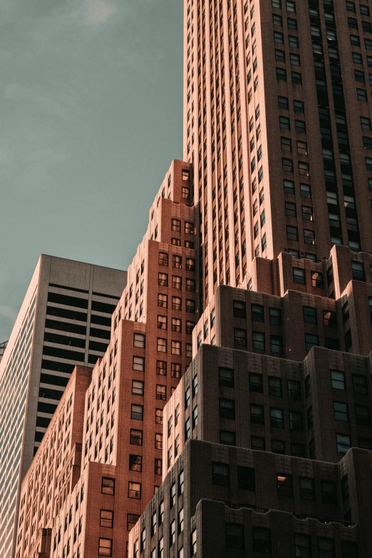 a couple of tall buildings sitting next to each other, by Adam Rex, pexels contest winner, modernism, art deco style, ny, brick building, flesh buildings