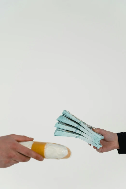 a close up of a person handing something to another person, by artist, arbeitsrat für kunst, drugstore, made of money, with a white background, foam