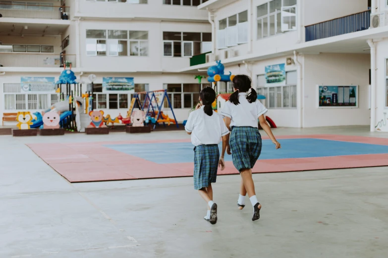 a couple of young girls playing a game of frisbee, pexels contest winner, vancouver school, completely empty, school uniform, walking away, jordan grimmer and natasha tan