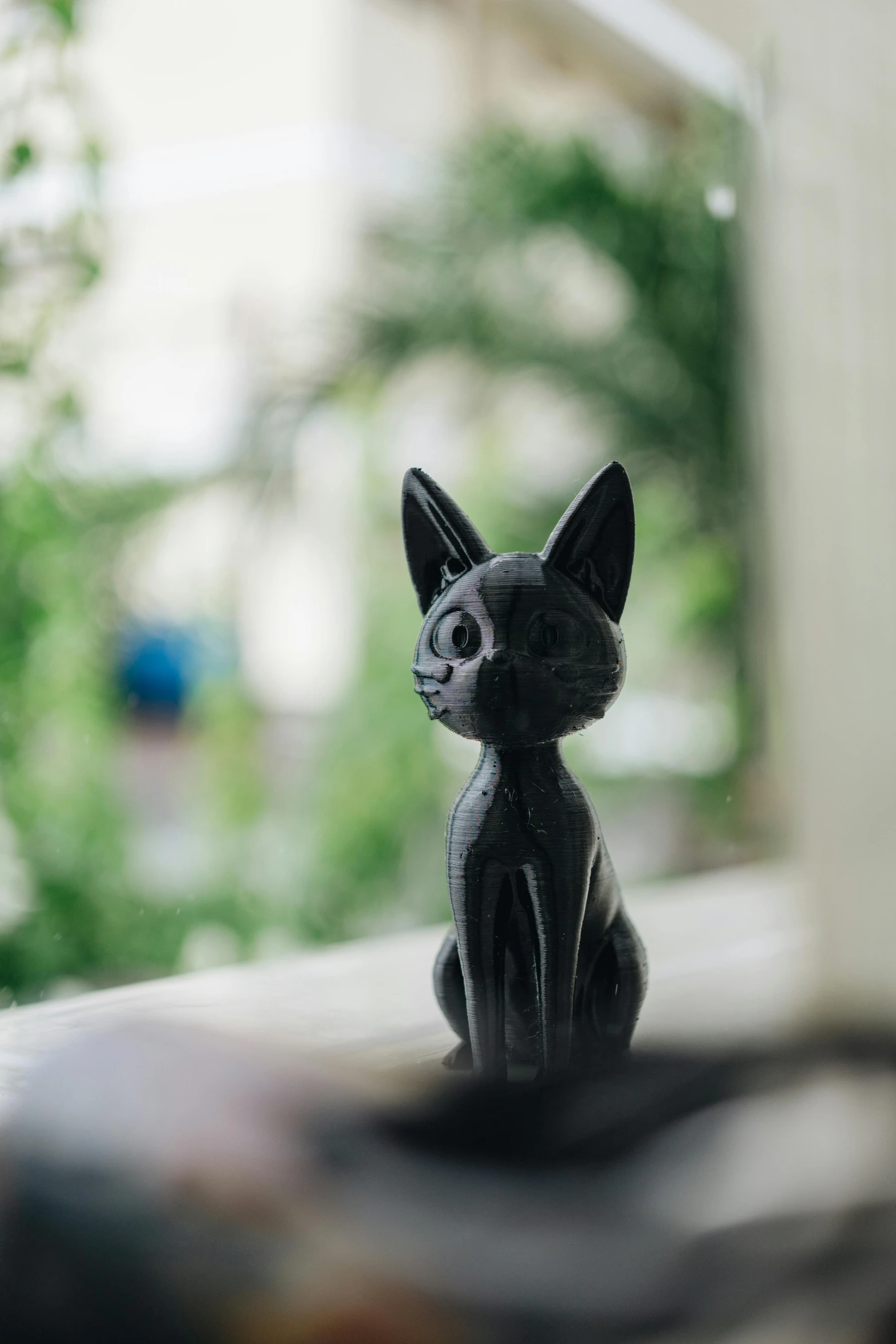 a black cat figurine sitting on a window sill, unsplash, new sculpture, close up front view, 3 d print, outside, ready to model