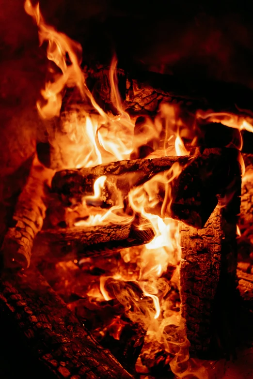 a close up of a fire in a fireplace, an album cover, pexels, process art, outdoor campfire pit, avatar image, multiple stories, about to step on you