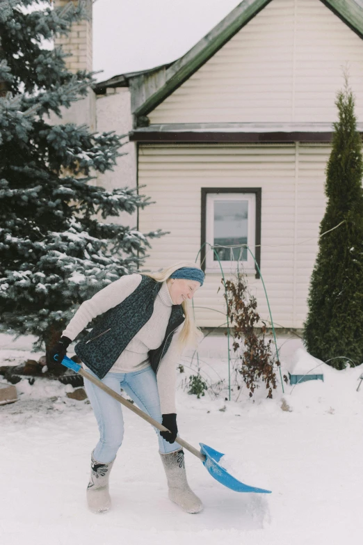 a woman shovels snow in front of a house, pexels contest winner, crystal maiden, gif, profile image, head down