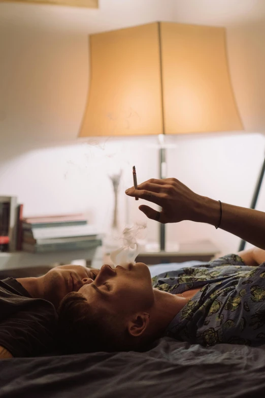 a man laying on top of a bed next to a woman, inspired by Nan Goldin, trending on pexels, visual art, smoking a magical bong, soft light 4k, teenage boy, movie clip