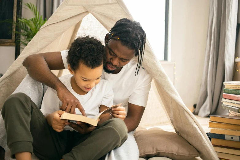 a father and son reading a book together, pexels contest winner, teepee, black man, with book of science, canopee