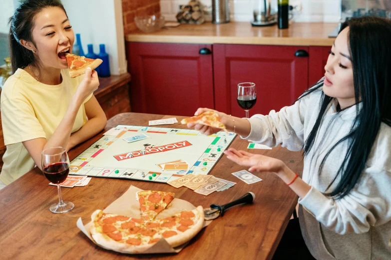 a couple of women sitting at a table eating pizza, by Julia Pishtar, pexels contest winner, board game, in house, 15081959 21121991 01012000 4k, thumbnail