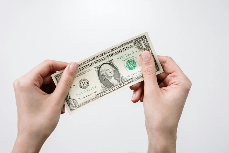 a person holding a one dollar bill in their hands, by Daniel Lieske, pexels contest winner, renaissance, on a white background, background image, caucasian, thumbnail