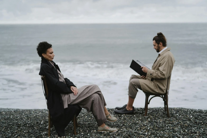 two people sitting next to each other on a beach, a portrait, by Anita Malfatti, pexels contest winner, renaissance, overcast mood, giving an interview, scene from live action movie, connection rituals