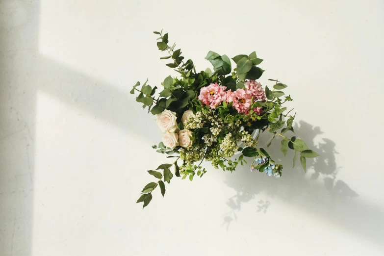 a bouquet of flowers sitting on top of a white wall, lightweight, light pink tonalities, front facing, like small pieces