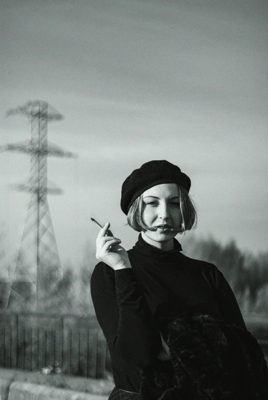 a black and white photo of a woman smoking a cigarette, inspired by August Sander, unsplash, surrealism, berets, sovietwave aesthetic, 🤤 girl portrait, in a landscape