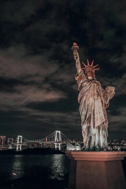 the statue of liberty is lit up at night, a statue, pexels contest winner, american romanticism, 🚿🗝📝, background image, bronze statue and silver, cover shot