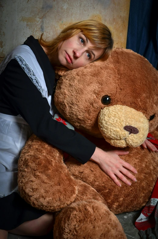 a woman is hugging a large teddy bear, an album cover, pexels, sad look, russian, brown, homemade